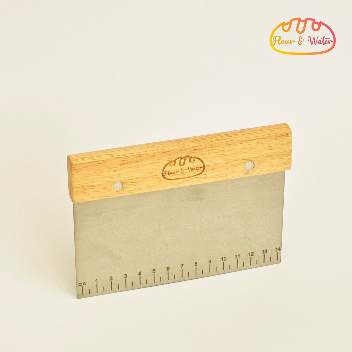 Bench scraper with measurement ruler on a white background