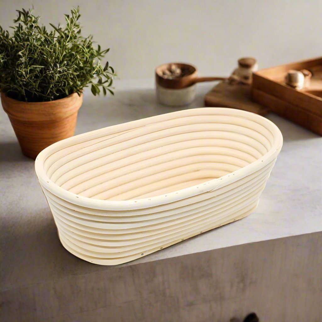Oval rattan banneton proofing basket on a kitchen bench