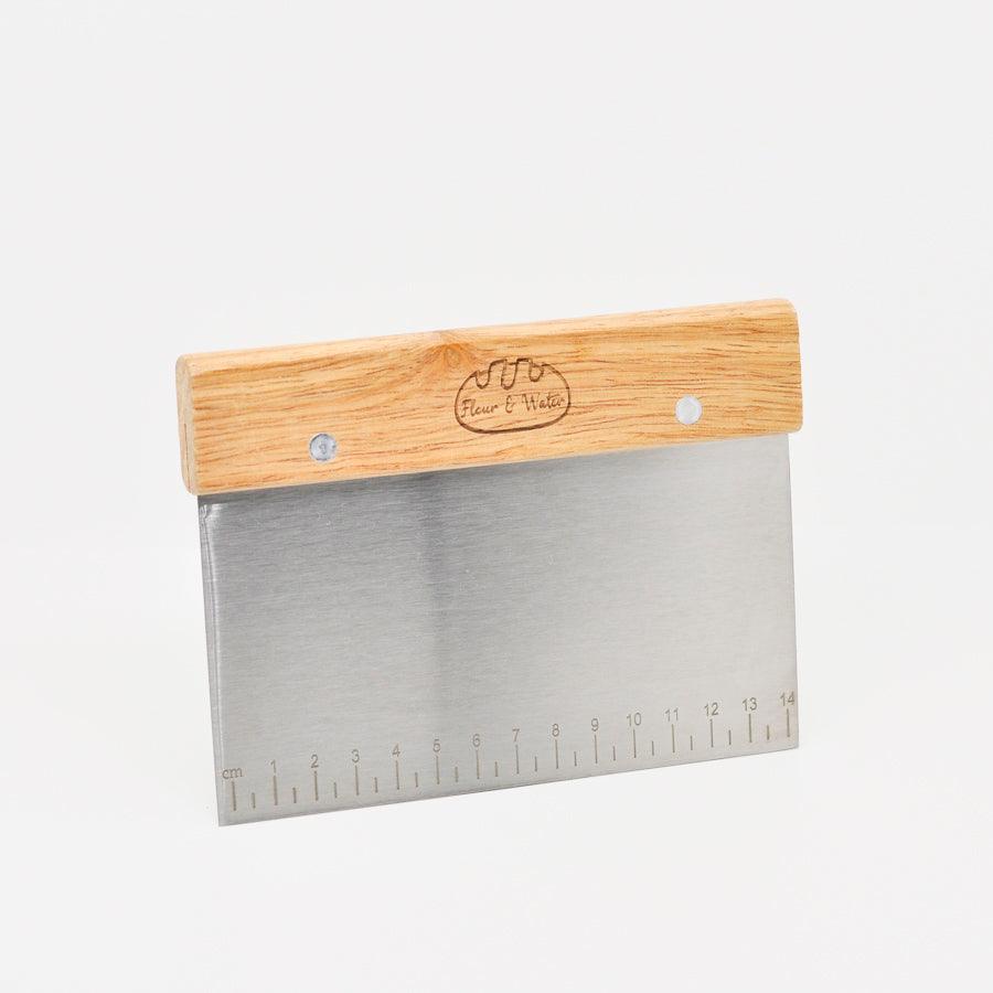 Stainless steel dough cutter with ruler edge, front view