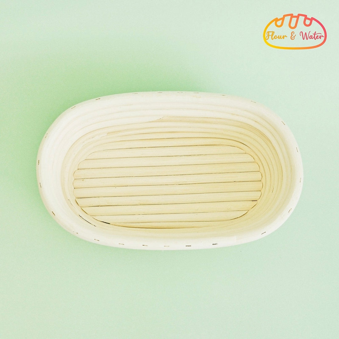 Empty oval rattan banneton showing the coiled grooves where sourdough dough can stick