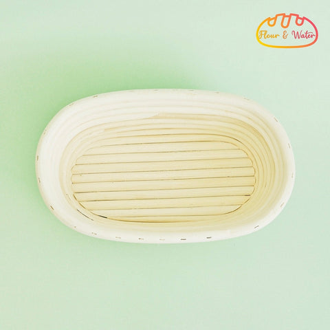 Empty oval rattan banneton showing the coiled grooves where sourdough dough can stick