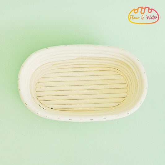 Empty oval rattan banneton showing the coiled grooves where sourdough dough can stick