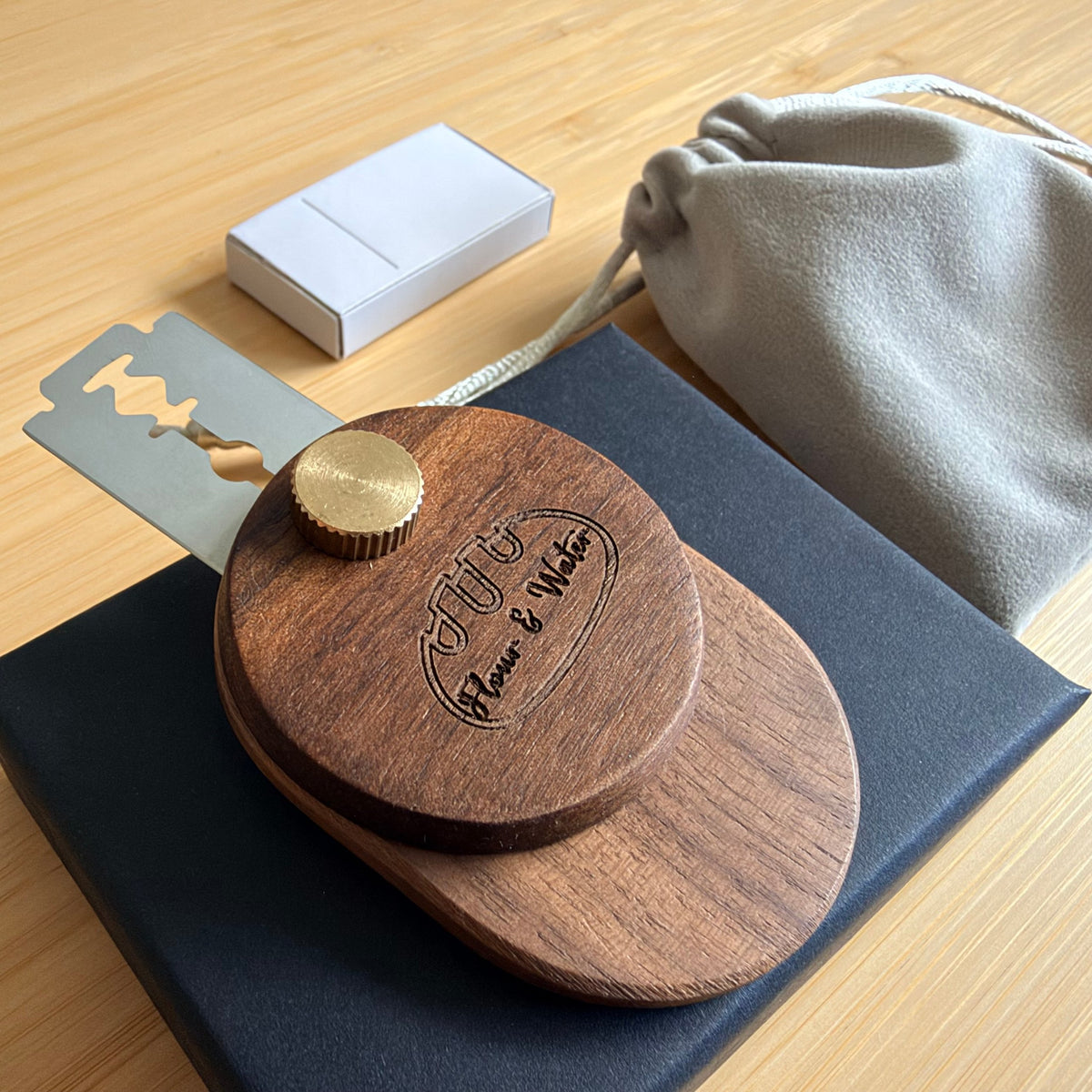 Walnut swivel bread lame with Flour & Water logo on black gift box
