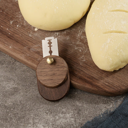 Walnut swivel bread lame beside scored sourdough dough