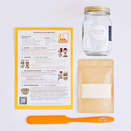 Bread-making kit with a jar, package, and recipe card on a white background