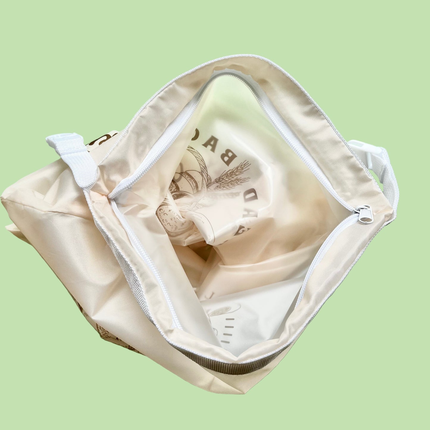 Open beige bag with a white interior on a light green background